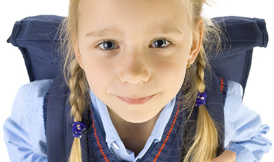 Girl in school uniform looking at camera